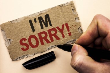 Writing note showing  I m Sorry. Business photo showcasing Apologize Conscience Feel Regretful Apologetic Repentant Sorrowful written by Man Holding Marker on tear Cardboard Piece Plain Background. clipart