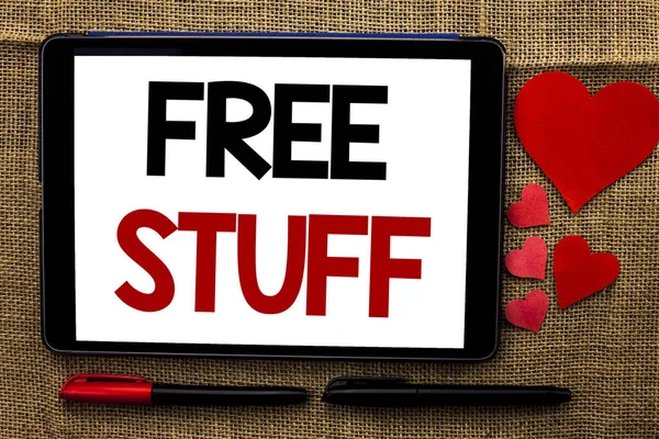 Handwriting text writing Free Stuff. Concept meaning Complementary Free of Cost Chargeless Gratis Costless Unpaid written on Tablet on the jute background Hearts and Pens next to it. — Stock Photo, Image