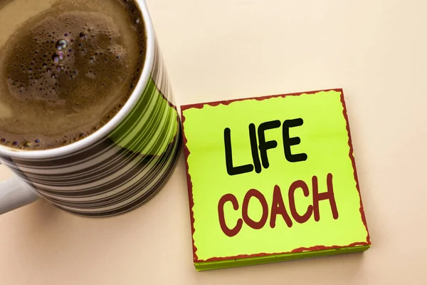 Word writing text Life Coach. Business concept for Mentoring Guiding Career Guidance Encourage Trainer Mentor written on Green Sticky Note Paper on the plain background Coffee Cup next to it.