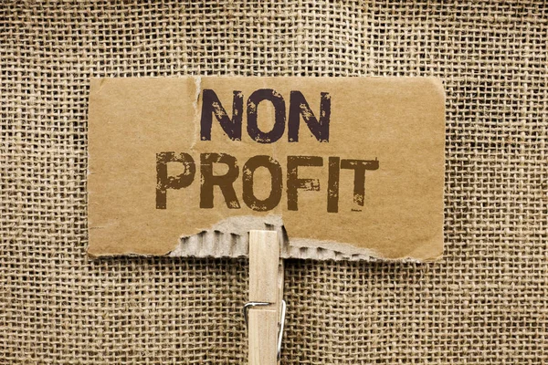 Nota di scrittura che mostra No Profit. Foto d'affari in mostra benefico Wrothless Philanthropy Aid Unlucrative Profitless scritto su Cardboard Piece Holding By Clip sullo sfondo di iuta . — Foto Stock