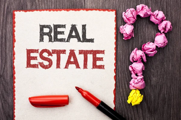 Writing note showing  Real Estate. Business photo showcasing Residential Property Building Covered Land Chattels Real written on Cardboard Piece With Marker wooden background Question Mark.