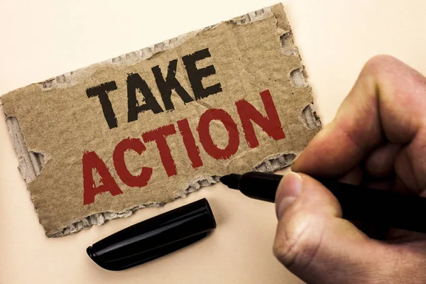 Writing note showing  Take Action. Business photo showcasing Strategy Future Actions Procedure Activity Goal Objective written by Man Holding Marker on tear Cardboard Piece Plain Background.