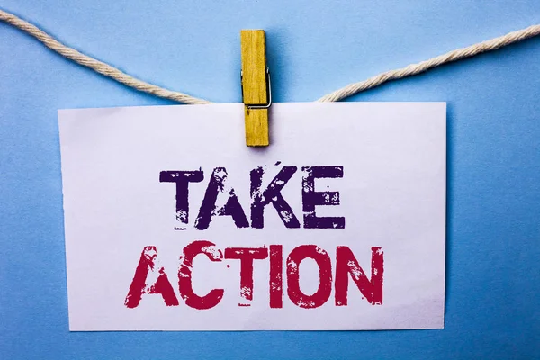 Text sign showing Take Action. Conceptual photo Strategy Future Actions Procedure Activity Goal Objective written on White Note Paper hanging with rope on the plain background Clip.