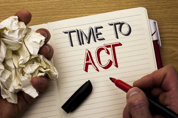 Handwriting text Time To Act. Concept meaning Action Moment Strategy Deadline Perform Start Effort Acting written by Man on Notebook Book Holding Marker on the wooden background Pen next to it.
