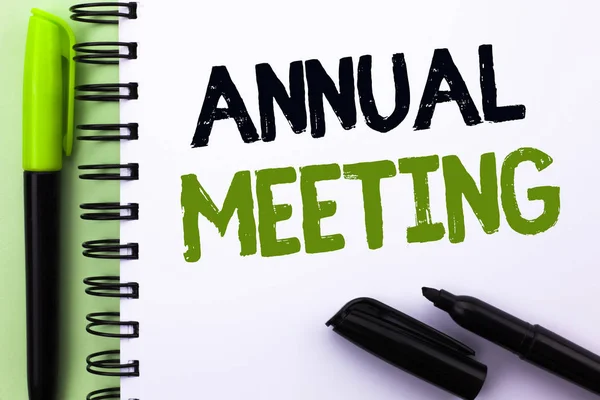 Text sign showing Annual Meeting. Conceptual photo Yearly Company Assembly Business Conference Report Event written on Notebook Book on the Green background Marker and Pen next to it.