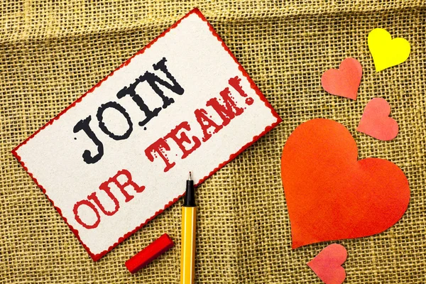Handwriting text Join Our Team Motivational Call. Concept meaning Invitation to Work Together Job Offer written on Sticky Note Paper by Pointer on the jute background Love Hearts next to it.