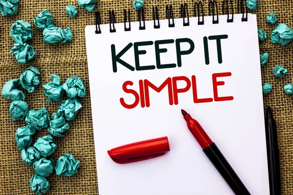 Writing note showing  Keep It Simple. Business photo showcasing Simplify Things Easy Understandable Clear Concise Ideas written on Notebook Book on the jute background Markers next to it.