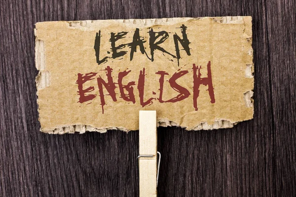 Word writing text Learn English. Business concept for Study another Language Learn Something Foreign Communication written on Cardboard Piece Holding With Clip on the wooden background.