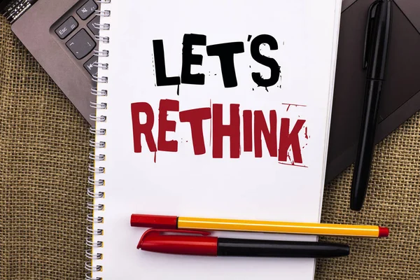 Writing note showing  Let Us Rethink. Business photo showcasing Give people time to think things again Remodel Redesign written on Notebook Book placed on Laptop with jute background Pens — Stock Photo, Image