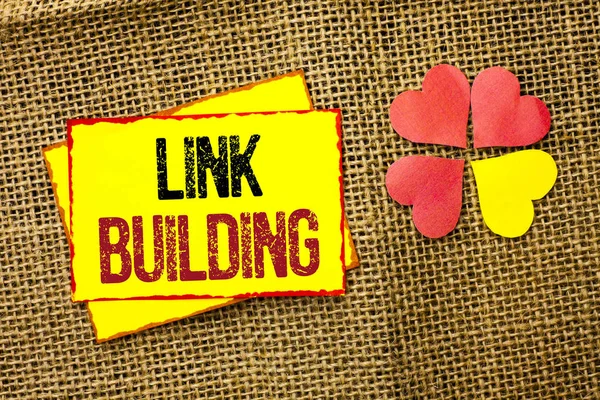 Word writing text Link Building. Business concept for Process of acquiring hyperlinks from other websites Connection written on Sticky Note Paper on the jute background Love Hearts next to it.