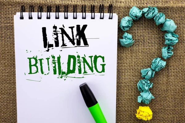 Writing note showing  Link Building. Business photo showcasing Process of acquiring hyperlinks from other websites Connection written on Notebook Book on the jute background Marker Ask for.
