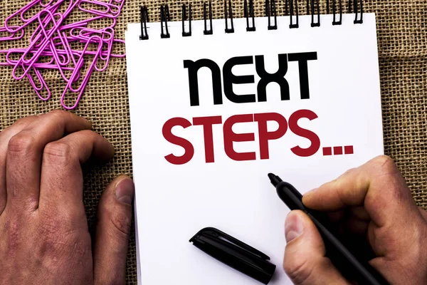 Text sign showing Next Steps.... Conceptual photo Following Moves Strategy Plan Give Directions Guideline written by Man Holding Marker on Notebook Book on the jute background Pins next to it