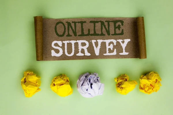 Handwriting text Online Survey. Concept meaning Digital Media Poll Customer Feedback Opinions Questionnaire written on Cardboard Paper on the plain background Paper Balls next to it.