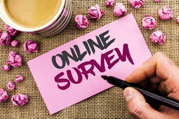 Conceptual hand writing showing Online Survey. Business photo text Digital Media Poll Customer Feedback Opinions Questionnaire written by Man Holding Marker on Paper on the jute background Cup