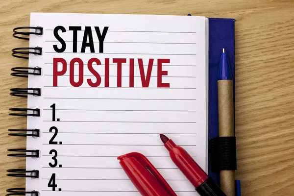 Handwriting text writing Stay Positive. Concept meaning Be Optimistic Motivated Good Attitude Inspired Hopeful written on Notebook Book on the wooden background Marker and Pencil next to it. — Stock Photo, Image