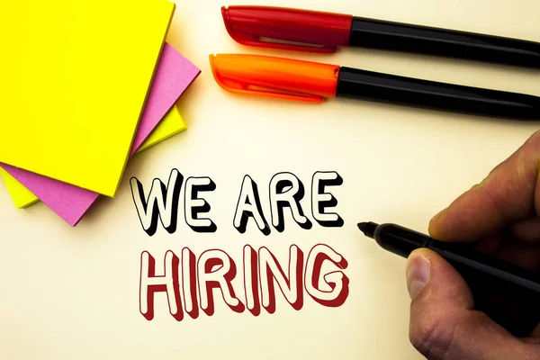 Handwriting text writing We Are Hiring. Concept meaning Talent Hunting Job Position Wanted Workforce HR Recruitment written by Marker on the plain background Pen and Sticky Notes next to it.