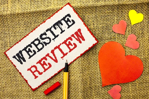 Handwriting text Website Review. Concept meaning Homepage Evaluation Customer Opinion Satisfaction Ranking written on Sticky Note Paper by Pointer on the jute background Love Hearts next to it.