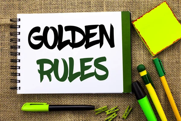 Text sign showing Golden Rules. Conceptual photo Regulation Principles Core Purpose Plan Norm Policy Statement written on Notebook Book on the jute background Pens Clips Sticky Note next to it.