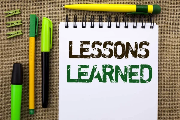 Word writing text Lessons Learned. Business concept for Experiences that should be taken into account in the future written on Notebook Book on the jute background Pens and Clips next to it. — Stock Photo, Image