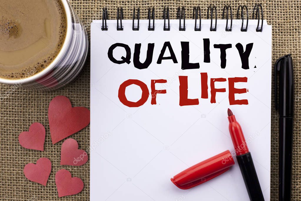 Conceptual hand writing showing Quality Of Life. Business photo showcasing Good Lifestyle Happiness Enjoyable Moments Well-being written on Notebook Book on the jute background Cup Hearts Pen