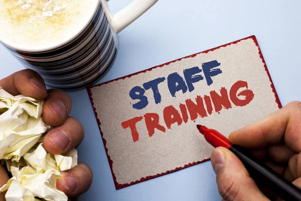 Writing note showing  Staff Training. Business photo showcasing Teaching Teamwork new things Employee Education Preparation written by Man on Cardboard Piece Holding Marker on the plain background
