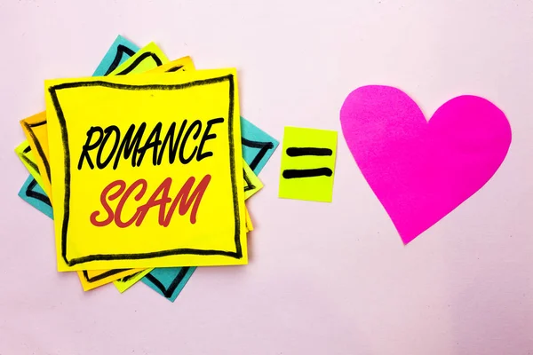Text sign showing Romance Scam. Conceptual photo Dating Cheat Love Embarrassed Fraud Cyber Couple Affair written on Yellow Sticky Note Paper on the plain background Pink Heart next to it. — Stock Photo, Image