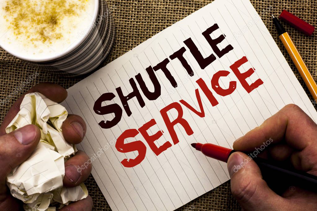 Writing note showing  Shuttle Service. Business photo showcasing Transportation Offer Vacational Travel Tourism Vehicle written by Man Holding Marker on Notebook Book on the jute background