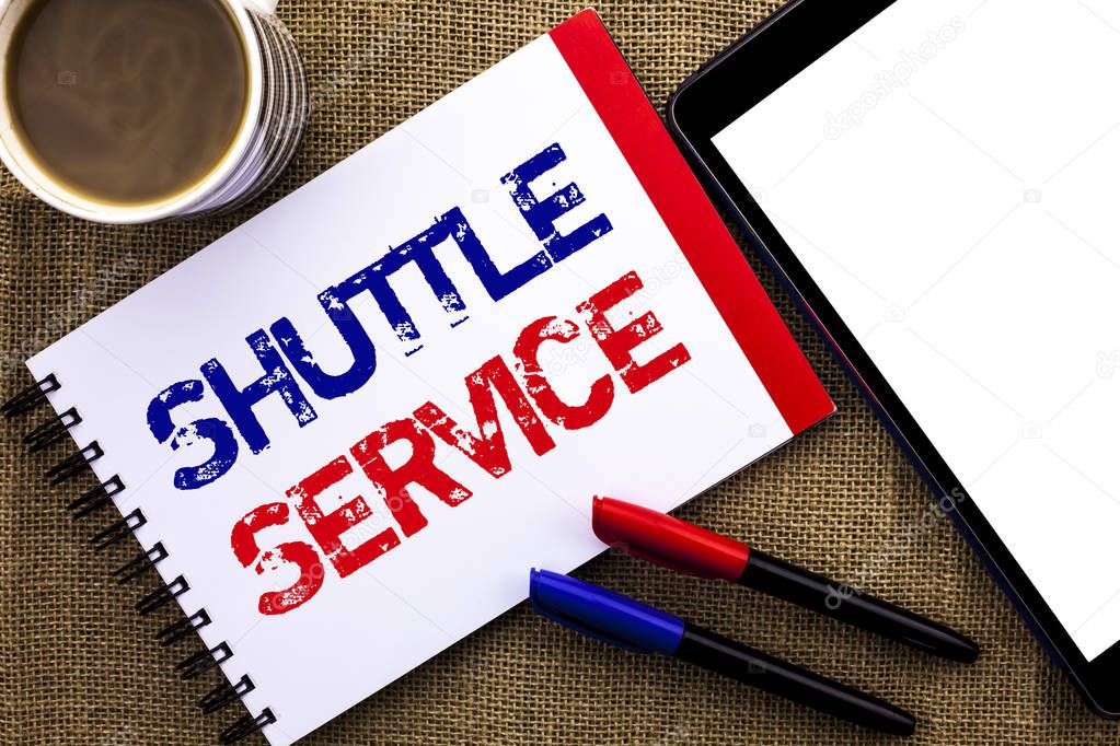 Handwriting text Shuttle Service. Concept meaning Transportation Offer Vacational Travel Tourism Vehicle written on Notebook Book on the jute background Tablet Coffee Cup and Pens next to it.