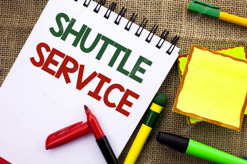 Writing note showing  Shuttle Service. Business photo showcasing Transportation Offer Vacational Travel Tourism Vehicle written on Notebook Book on the jute background Sticky Note Papers Pens