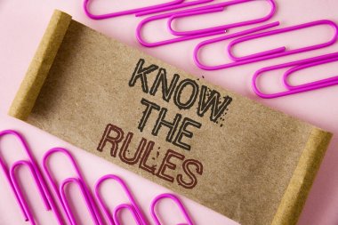Handwriting text writing Know The Rules. Concept meaning Understand terms and conditions get legal advice from lawyers written on Folded Cardboard paper piece on plain background within Paper Clips. clipart