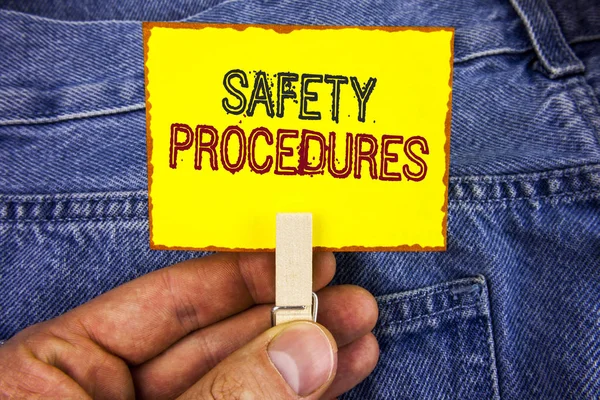 Word writing text Safety Procedures. Business concept for Follow rules and regulations for workplace security written on Yellow Sticky Note Paper holding by man with Clip on Jeans background