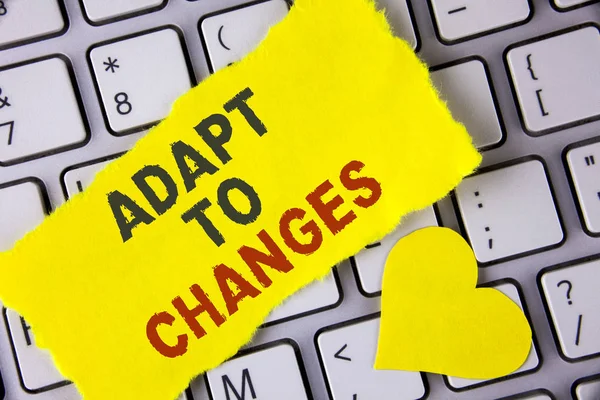 Word writing text Adapt To Changes. Business concept for Innovative changes adaption with technological evolution written on tear Sticky Note Paper placed on the Laptop Yellow Heart next to it. — Stock Photo, Image