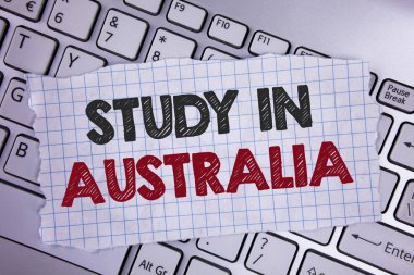 Text sign showing Study In Australia. Conceptual photo Graduate from oversea universities great opportunity written on Tear Notebook paper placed on the Laptop. clipart