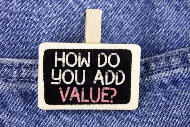 Conceptual hand writing showing How Do You Add Value Question. Business photo text Bring business progress contribute earn written on Wood Piece on the Jeans background. clipart