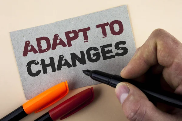 Conceptual hand writing showing Adapt To Changes. Business photo text Innovative changes adaption with technological evolution written by Man with Marker on Cardboard Piece on plain background