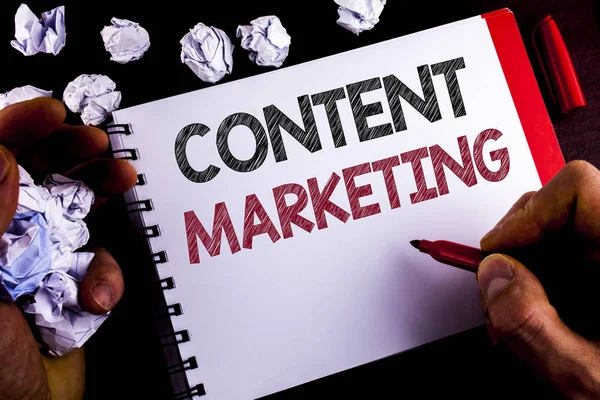 Writing note showing  Content Marketing. Business photo showcasing Digital marketing strategy files sharing of online content written by Man on Notepad holding Marker wooden background Paper Balls