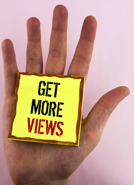 Text sign showing Get More Views. Conceptual photo Increase web traffic optimise blog strategy analyse digitally written on Yellow Sticky Note Paper placed on the Hand on the plain background. — Stock Photo, Image