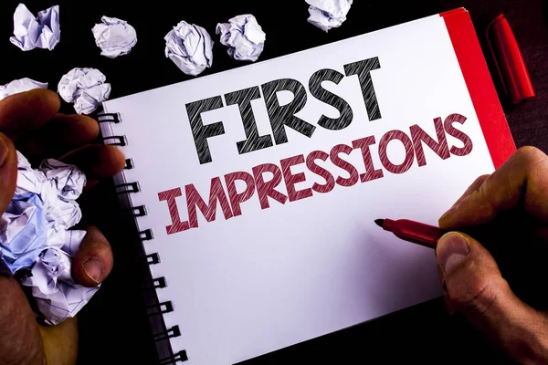 Writing note showing  First Impressions. Business photo showcasing Encounter presentation performance job interview courtship written by Man on Notepad holding Marker wooden background Paper Balls