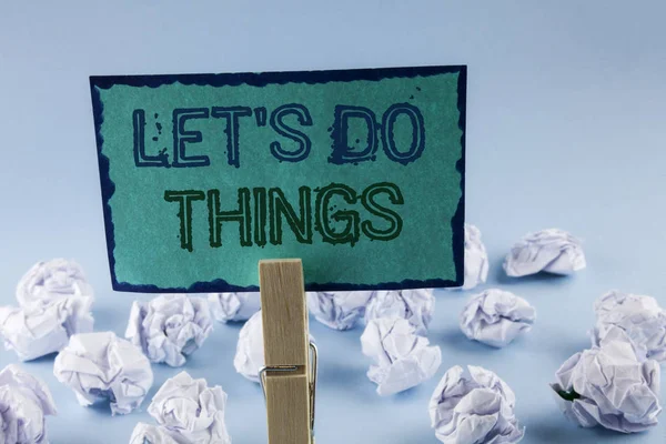 Text sign showing Let Us Do Things. Conceptual photo Try something new find happiness mastering it by practice written on Sticky Note Paper holding by Clip on plain background White Paper Balls — Stock Photo, Image