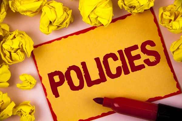 Writing note showing  Policies. Business photo showcasing Business Company or Government Rules Regulations Standards written on Sticky Note paper within Paper Balls on plain background.