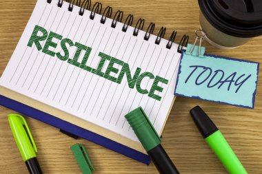 Writing note showing  Resilience. Business photo showcasing Capacity to recover quickly from difficulties Persistence written on Noteoad on wooden background Today Cup Pen Marker next to it clipart
