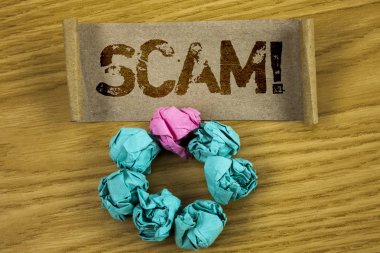 Aldatmaca motivasyonel ara gösterilen not yazma. Dürüst olmayan hareket dolandırıcılık insanları kandırmak katlanmış karton kağıt parçası ahşap arka plan üzerinde kağıt topları yazılı para kazanmak için vitrine iş fotoğraf