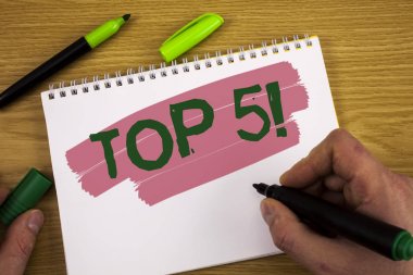 Kavramsal el Top 5 motivasyon ara gösterilen yazma. İş fotoğraf metin en iyi olanlar Kazananlar en popüler not defteri Marker Kalem ahşap arka plan üzerinde tutan adam tarafından yazıldı bestseller.