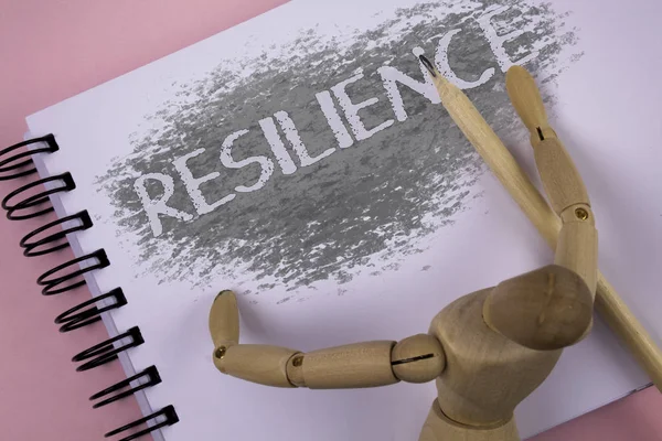 Escritura manual conceptual que muestra resiliencia. Foto de negocios mostrando Capacidad para recuperarse rápidamente de las dificultades Persistencia escrita en el bloc de notas de fondo liso de madera Juguete Articulado Lápiz —  Fotos de Stock