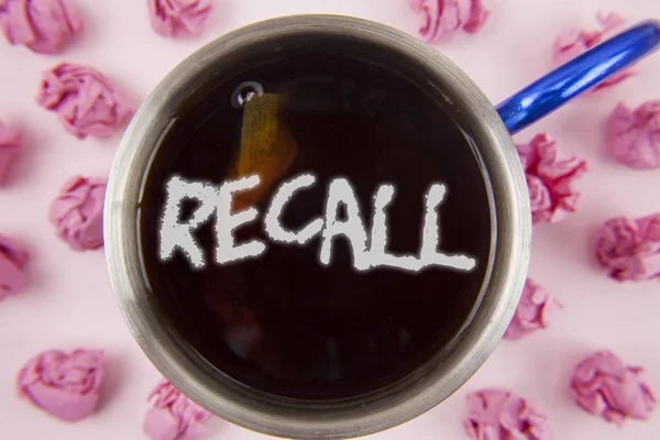 Conceptual hand writing showing Recall. Business photo showcasing Bring back to memory Ordering the return of a person or product written on Tea in Cup within Paper Balls on plain background. — Stock Photo, Image