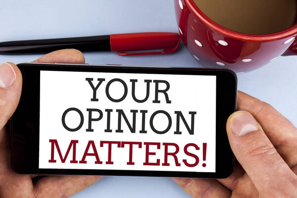 Word writing text Your Opinion Matters Motivational Call. Business concept for Client Feedback Reviews are important written on Mobile Phone Screen holding by man on the plain background Cup Marker