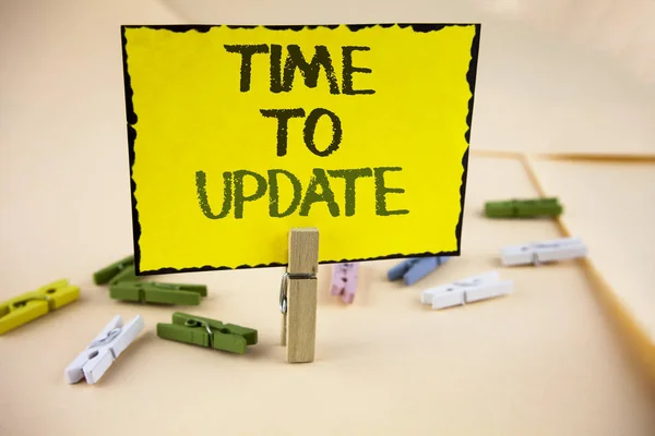 Writing note showing  Time To Update. Business photo showcasing Renewal Updating Changes needed Renovation Modernization written on Yellow Sticky Note Paper on plain background Wooden Clips. — Stock Photo, Image