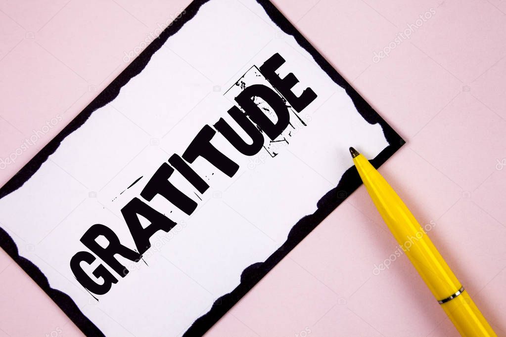 Handwriting text Gratitude. Concept meaning Quality of being thankful Appreciation Thankfulness Acknowledge written on White Sticky note paper on plain Pink background Pen next to it.