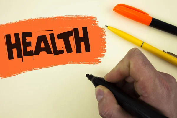 Writing note showing  Health. Business photo showcasing State of being free from Illness Injuries Mental Physical condition written by Man holding Marker on painted background Pens next to it. — Stock Photo, Image
