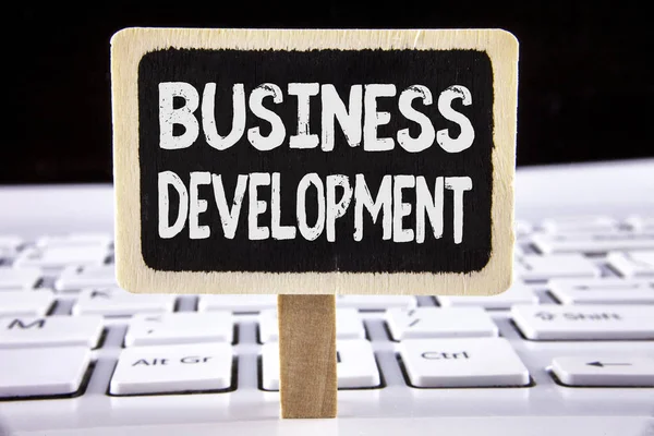 Word writing text Business Development. Business concept for Develop and Implement Organization Growth Opportunities written on Wooden Notice Board placed on the Laptop. — Stock Photo, Image